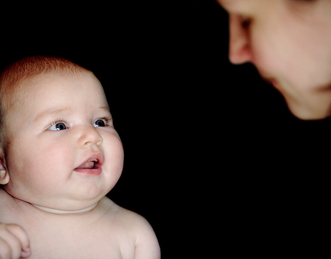 Mother and baby face to face, Dösingen, Bavaria, Germany