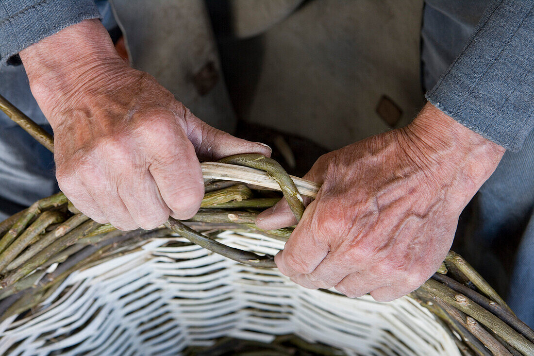 Hands of a basket weaver at a festival at Schloss Fasanerie Castle, near Fulda, Rhoen, Hesse, Germany