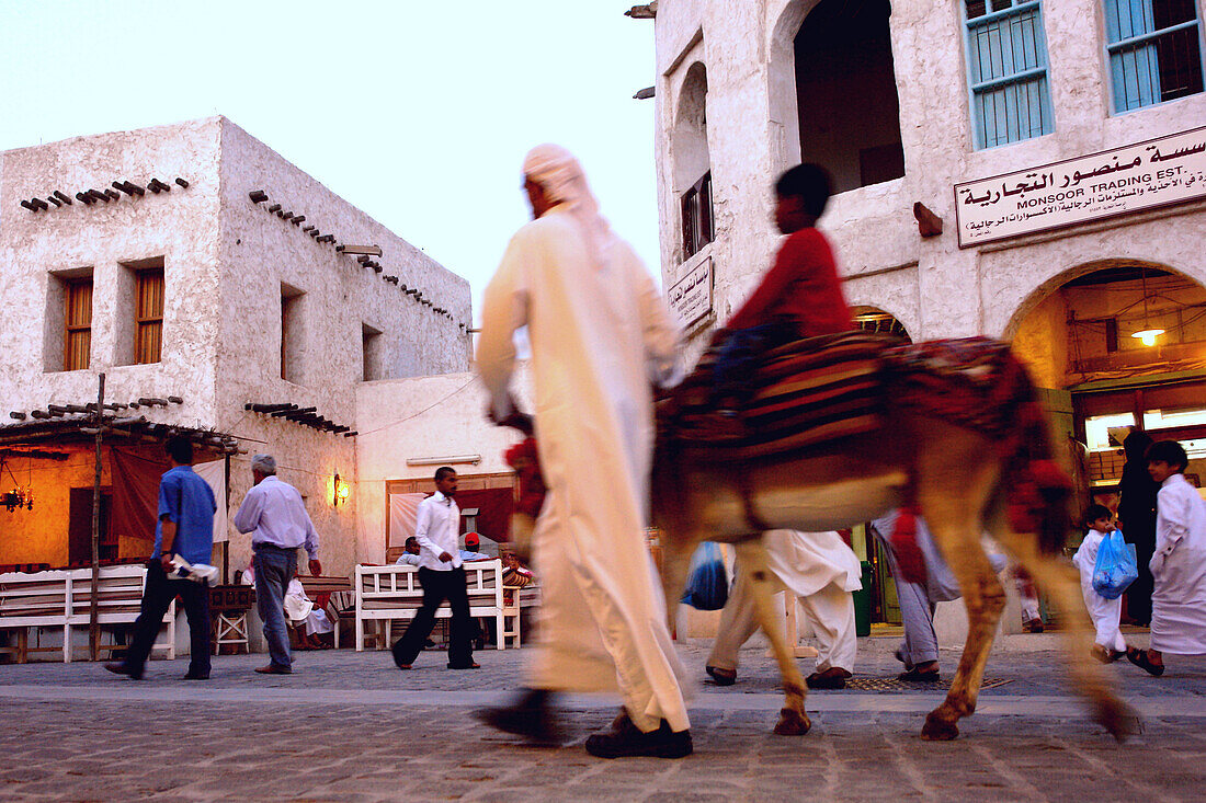 Man with child on donkey, Traditional Souk in Doha, Qatar