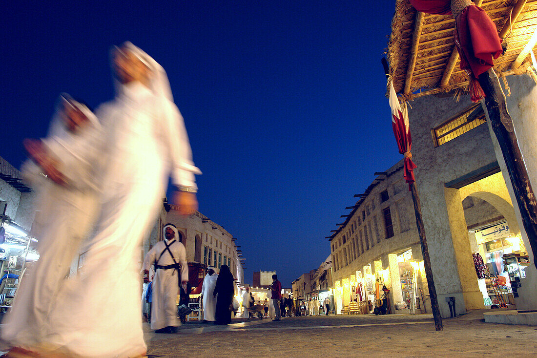 People walking through a commercial shopping area, Traditional Souk in Doha, Qatar