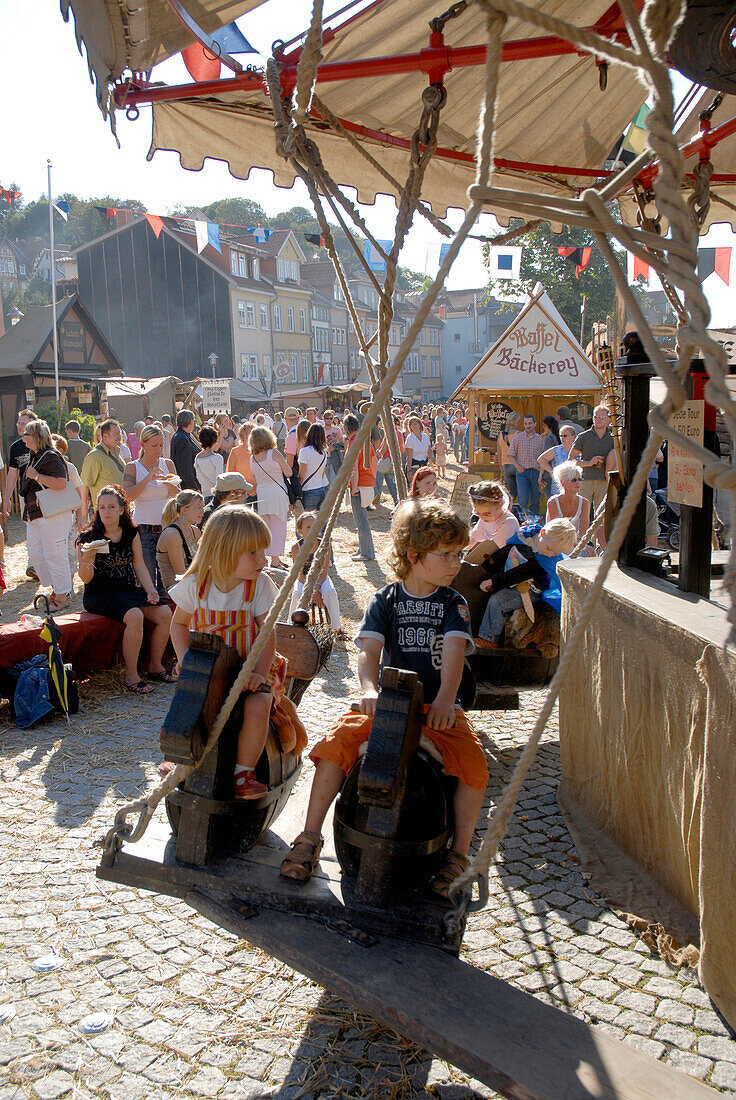 Children on a medieval merry-go-round at a festival, Luther fair, Eisenach, Germany