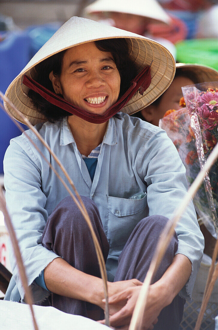 A local woman, vendor at a market, City Life, Hoi An, Vietnam