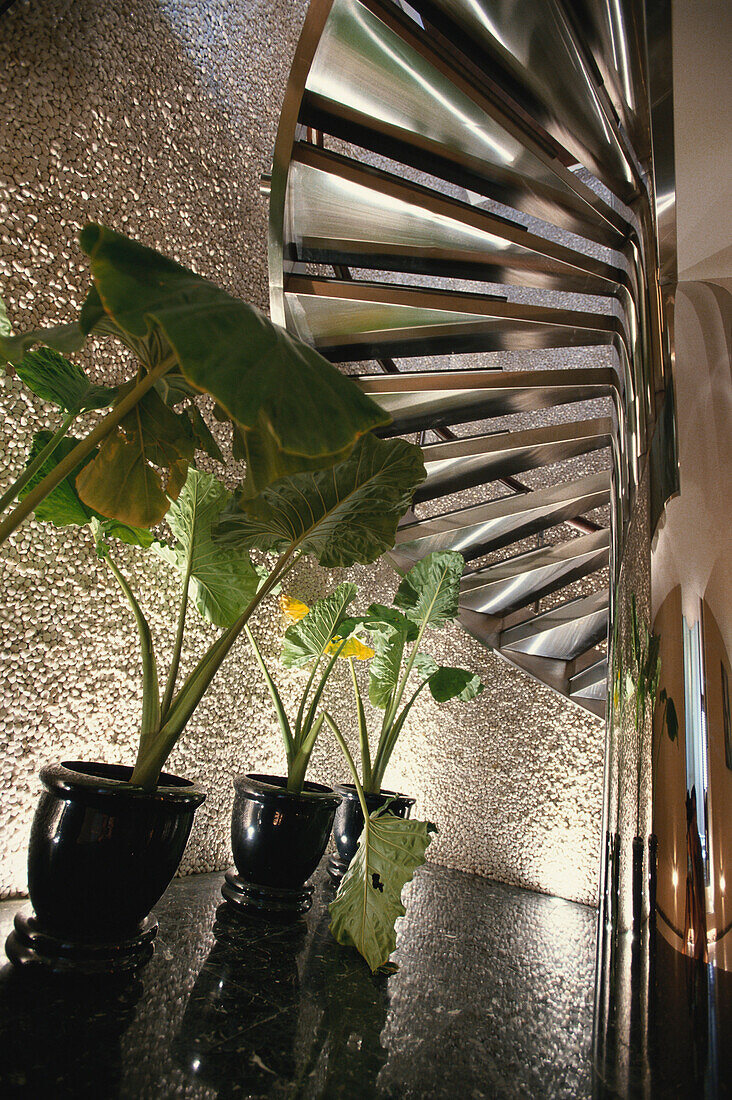 Detail of a spiral staircase, stairs inside Hotel Banyan Tree Spa with plants, Bangkok, Thailand