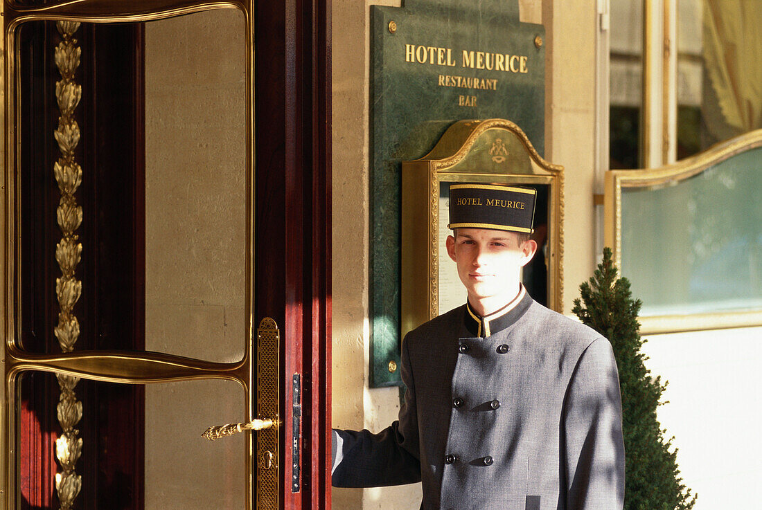 Doorman, bellboy holding door open, Hotel Meurice, Paris, France