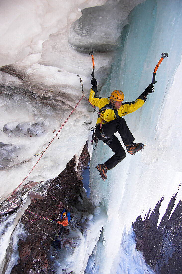 Ice climber on icy rock face, mount Cerro Marmolejo, Andes, Chile