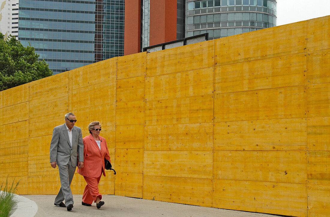 An older couple walking in Uno City, Vienna International Centre, Vienna, Austria