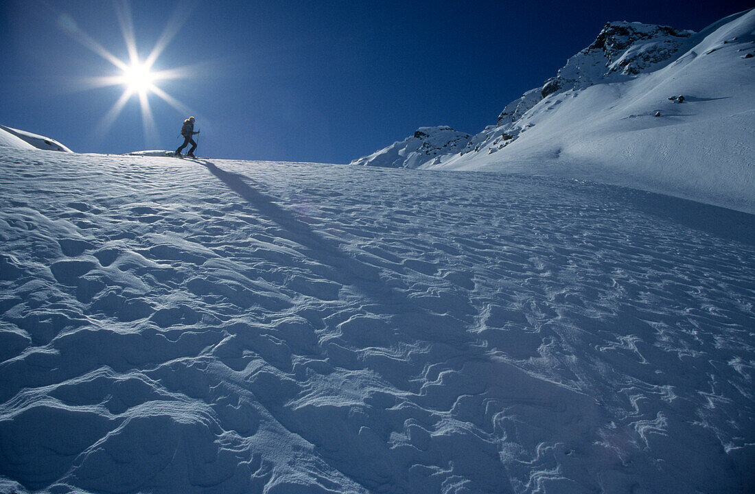 snow structure with backcountry skier in backlight, Laschadurella, Grisons, Switzerland