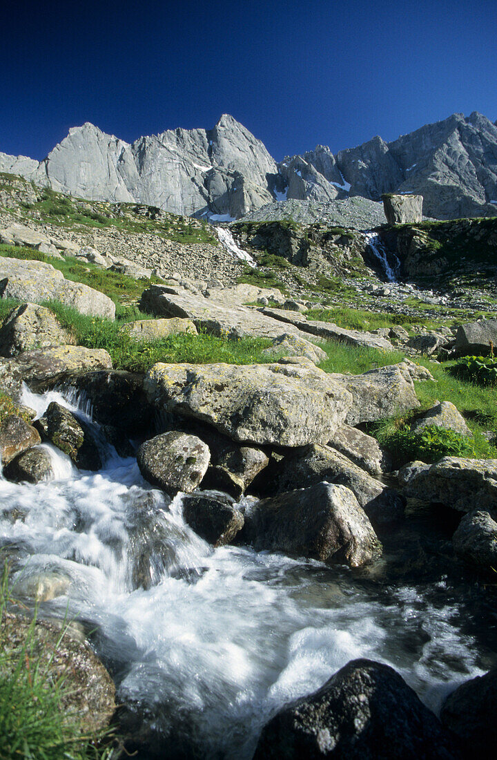 stream in Val di Mello with granite mountains, Bergell, Italy