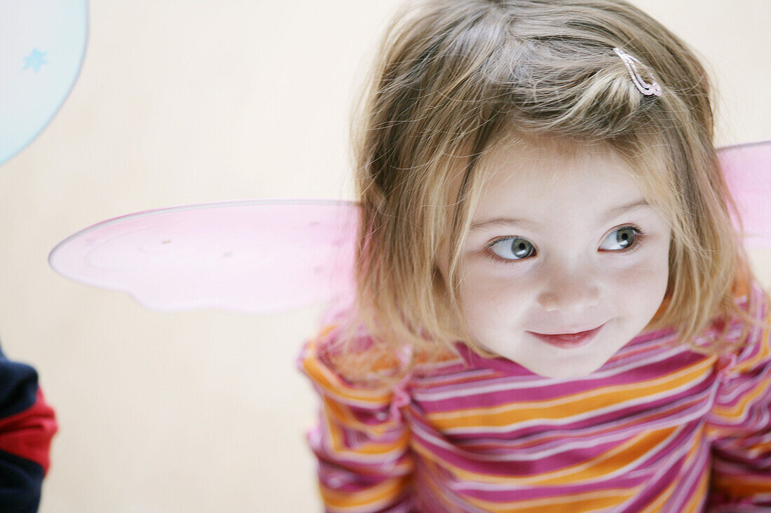 Girl (2-3 years) wearing butterfly wings