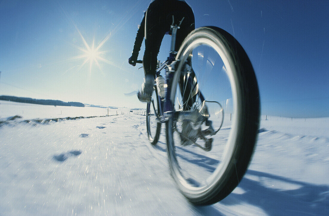 Mountainbiker in snow, 5 Lakes District, Upper Bavaria, Germany