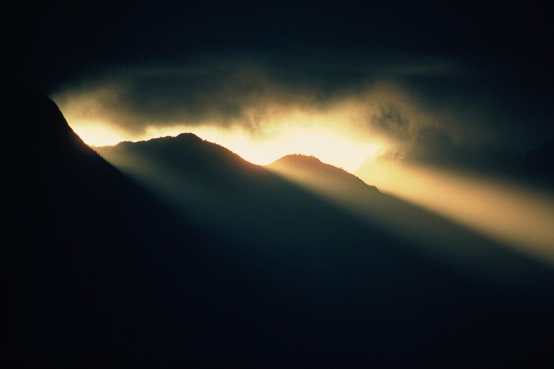 Sunrays through darkness above Pali Ridge, Oahu, Hawaii