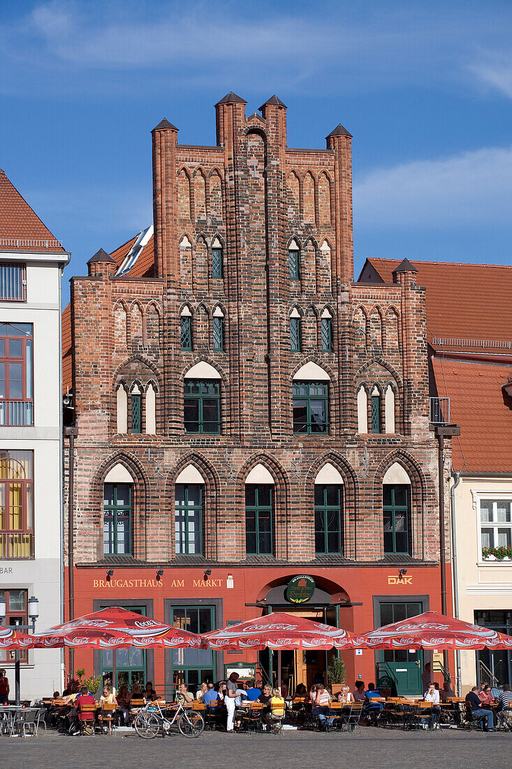 People relaxing in a pavement cafe at market square, Greifswald, Mecklenburg-Western Pomerania, Germany