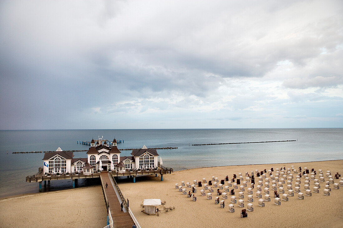 Sandy beach with beach chairs, pier in background, Sellin, Rugen island, Mecklenburg-Western Pomerania, Germany