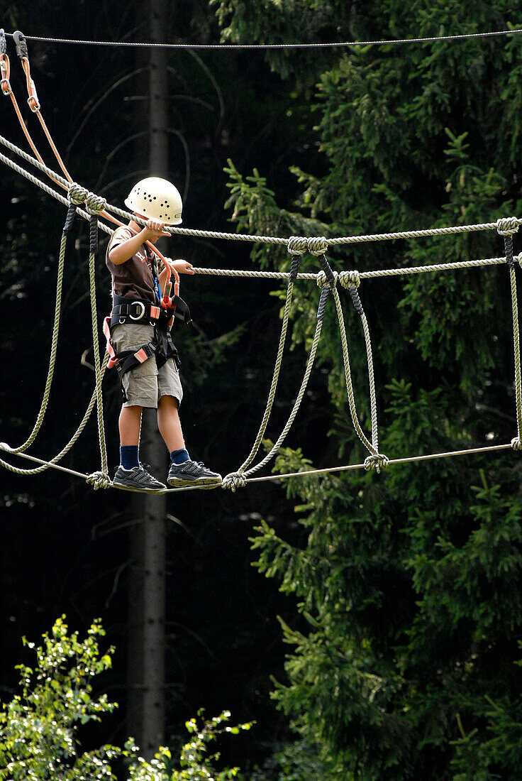 A child, boy, climber, on a high rope course, in Steinach, Thuringia, Germany