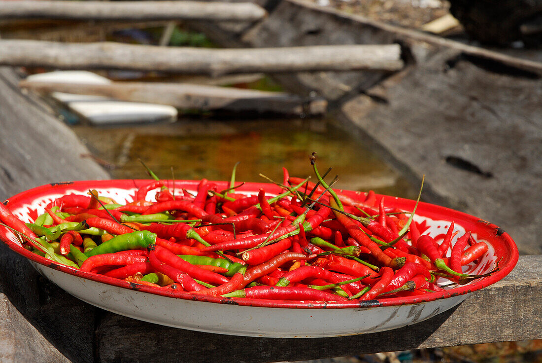 höllisch heiß, Chillis trocknen in einer Schüssel in einem Boot, Chao Nam Dorf, Surin Islands Marine National Park, Ko Surin, Phang Nga, Thailand