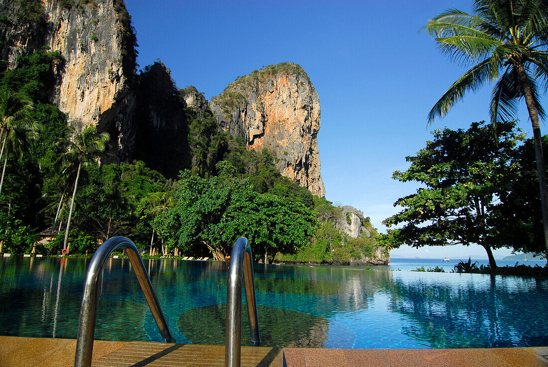 Pool in tropical garden of Hotel Rayavadee with limestone cliffs, Hat Phra Nang, Krabi, Thailand