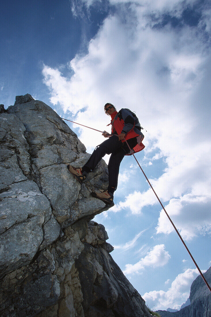 Climber rappeling down from mount Alpspitze, Garmisch-Partenkirchen, Bavaria, Germany