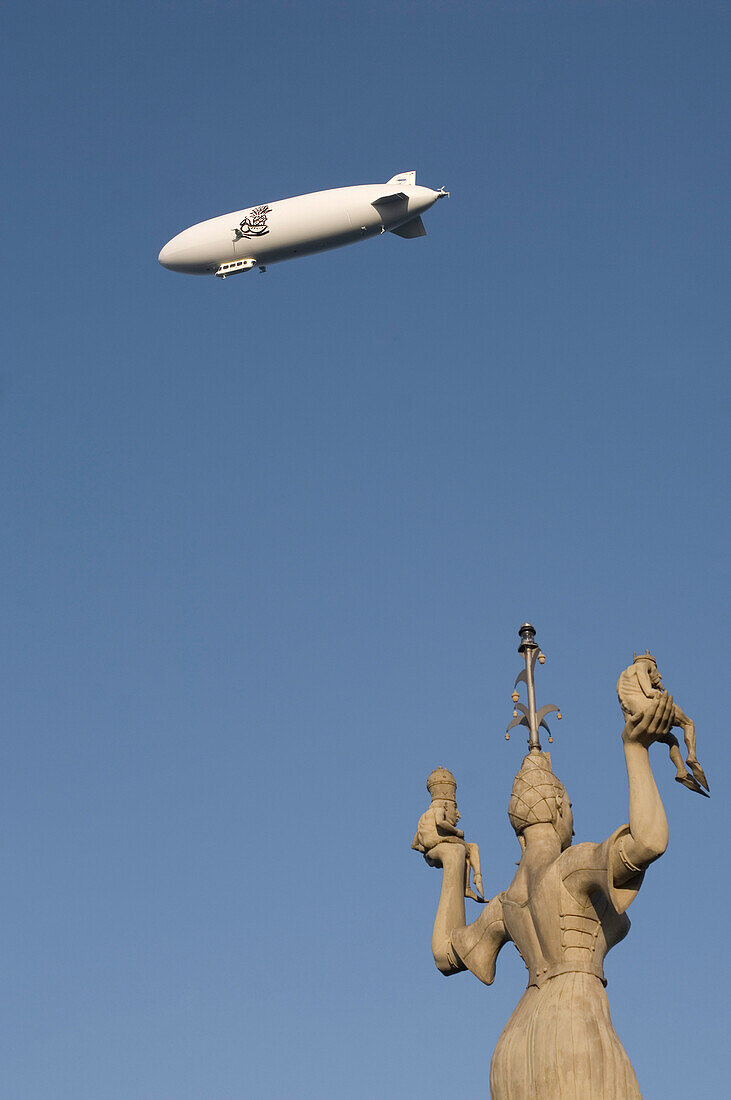 Airship in flight, Impera statue in foreground, Konstanz, Lake Constance, Baden-Wurttemberg, Germany