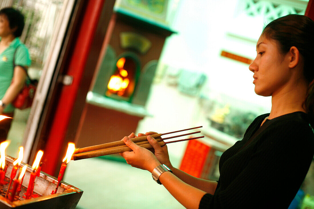 Woman with Joss Sticks and candles, Temple, Singapore
