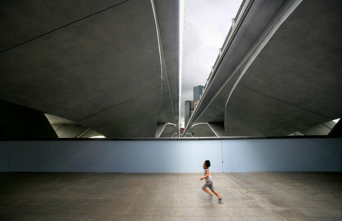 Child running near Esplanade, Singapore