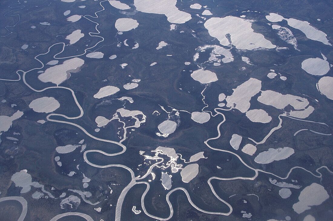 Aerial View of the North Siberian Tundra with lakes and meandering rivers in Spring, Siberia, Russia