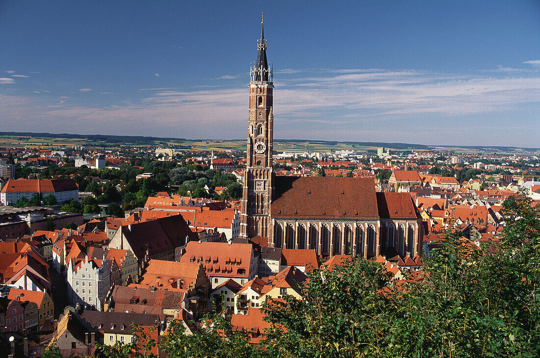 Towers and roofs of the medieval town surrounding the brick church and tower of St Martin, Landshut, Lower Bavaria, Germany