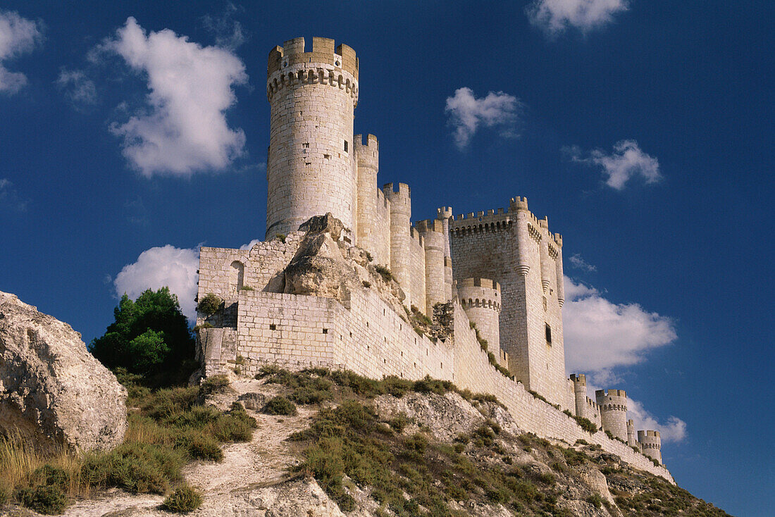 Castillo de Penafiel castle on the hilltop of a rocky ridge against the blue sky, Valladolid province, Castilla-Leon, Northern Spain