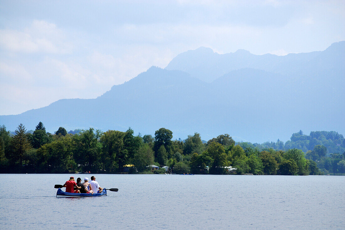 candadian kayak with four persons on board, Bavarian Alps in background, lake Riegsee, Upper Bavaria, Bavaria, Germany