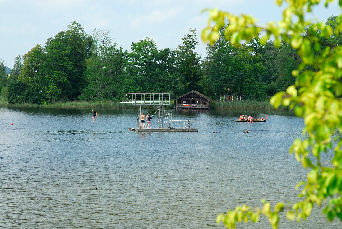 Bathers on float with diving platform, lake Staffelsee, Upper Bavaria, Bavaria, Germany