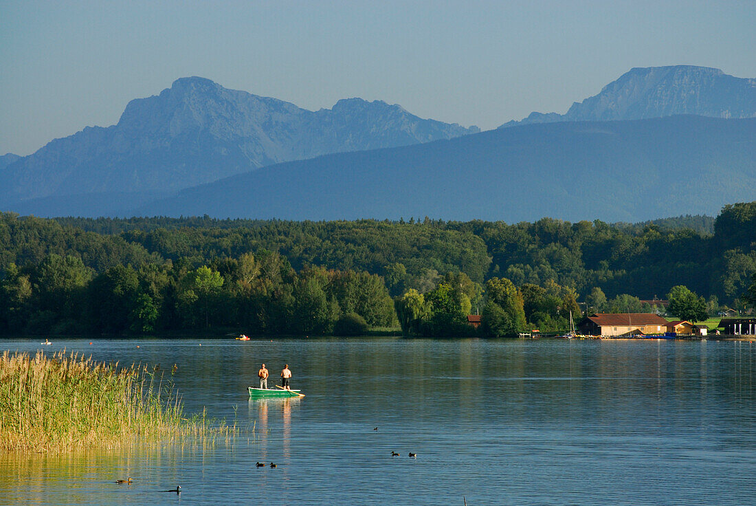 Two men fishing on lake Waginger See, Rupertiwinkel, Upper Bavaria, Bavaria, Germany