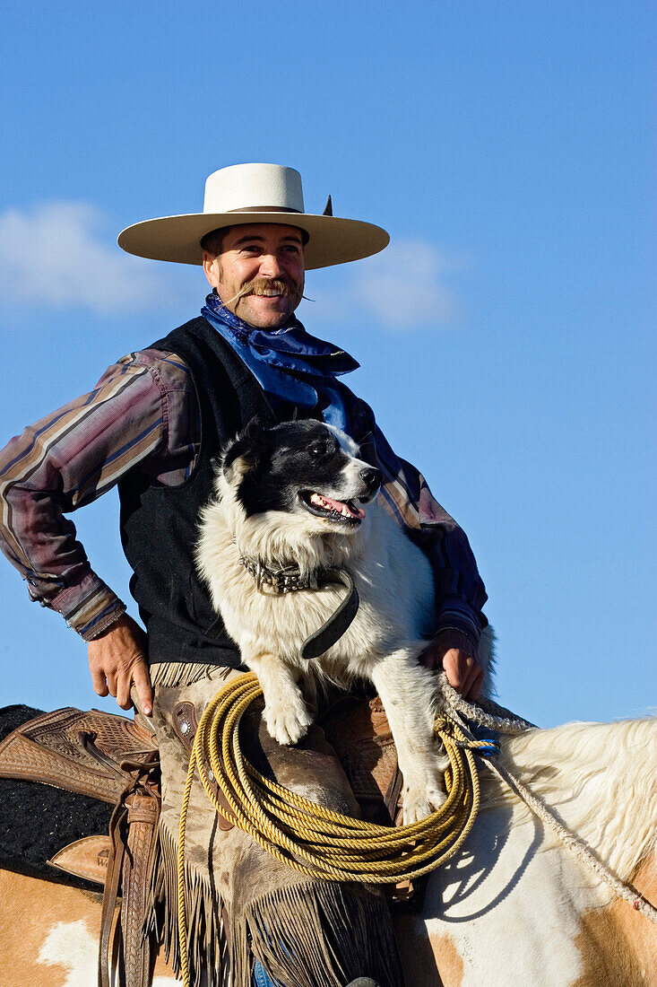 cowboy sitting on horseback with dog, wildwest, Oregon, USA