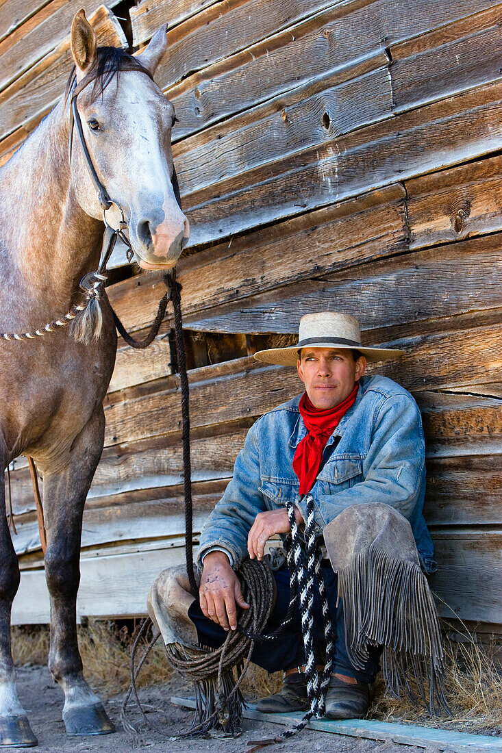 Cowboy mit Pferd vor Scheune, Wilder Westen, Oregon, USA