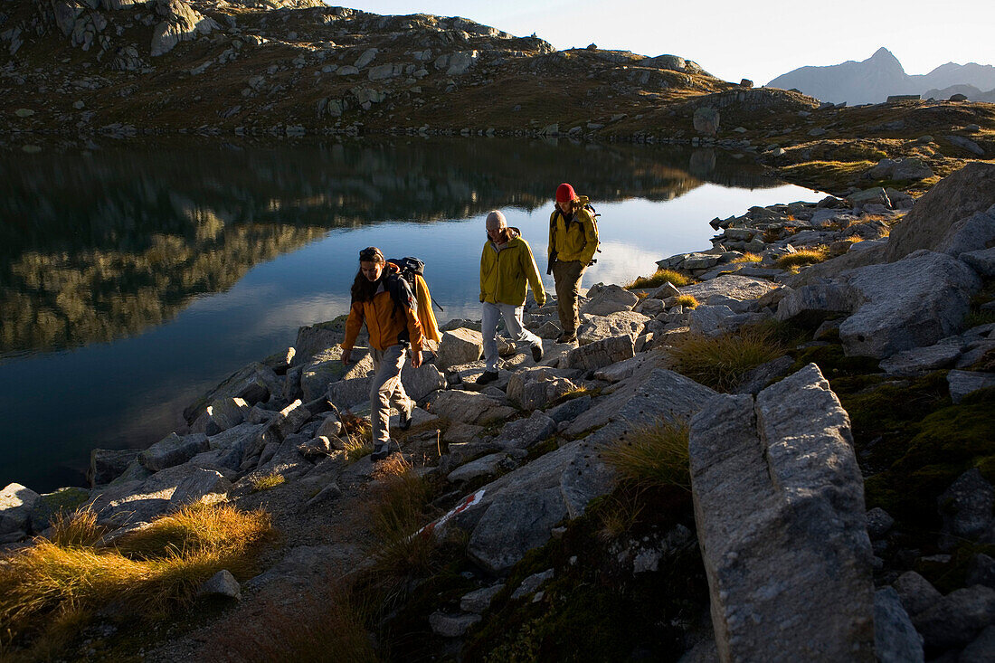 Young people hiking along Laghi d'Orsirora, Gotthard, Canton of Ticino, Switzerland