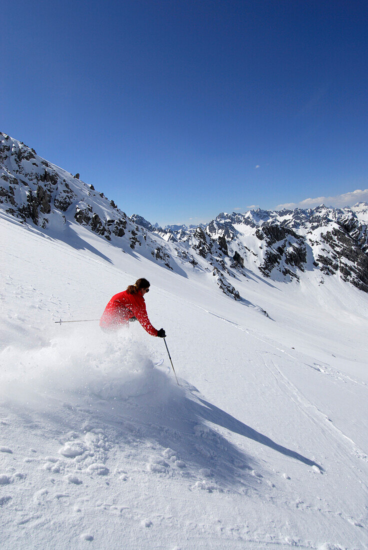 Skier skiing downhill, Steinkarspitze, Lechtal Alps, Vorarlberg, Austria