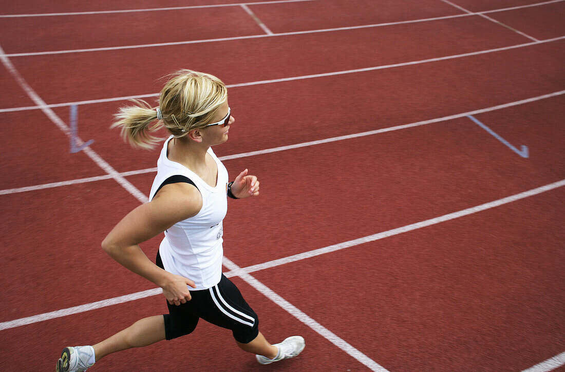 Woman runner on cinder track, , Carinthia, Austria