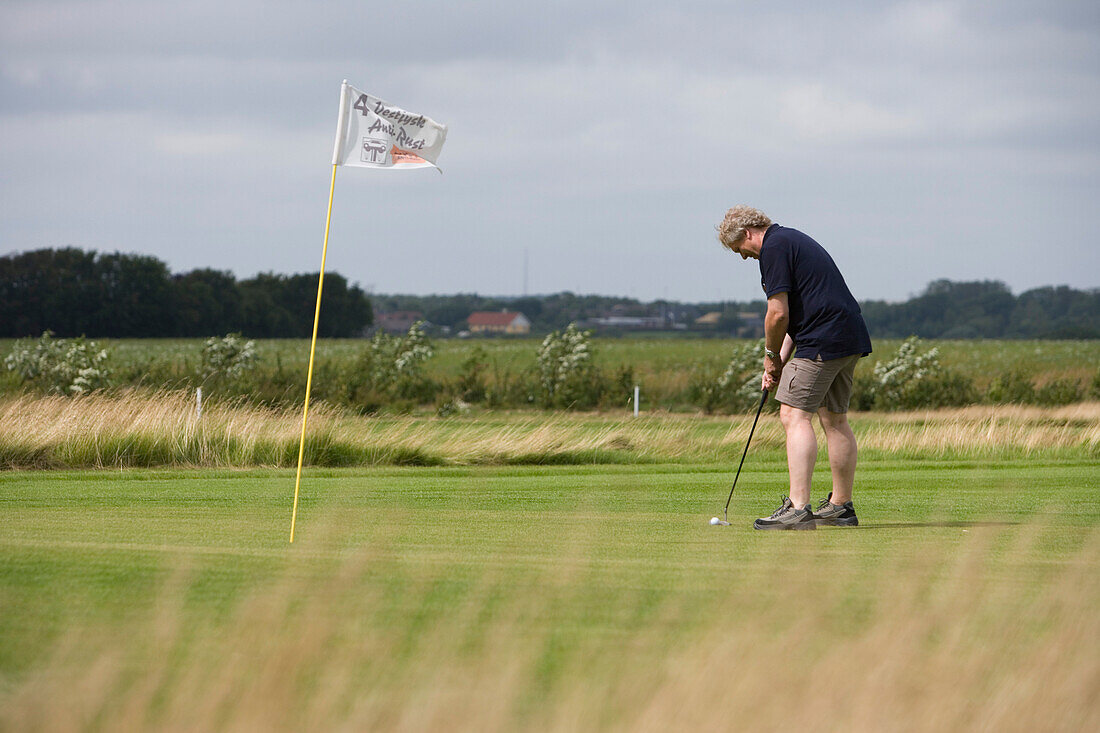 Man on Putting Green, Outrup Golfbane Golf Course, near Varde, Central Jutland, Denmark