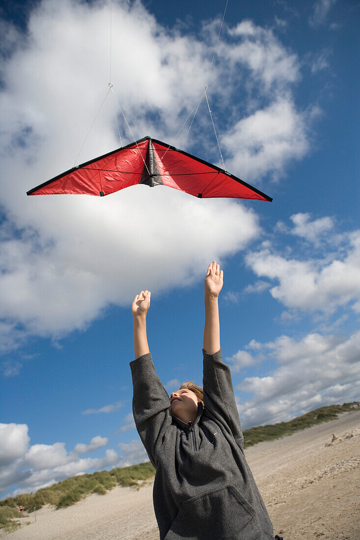 Boy flying a kite at beach, Sylt island, Schleswig-Holstein, Germany