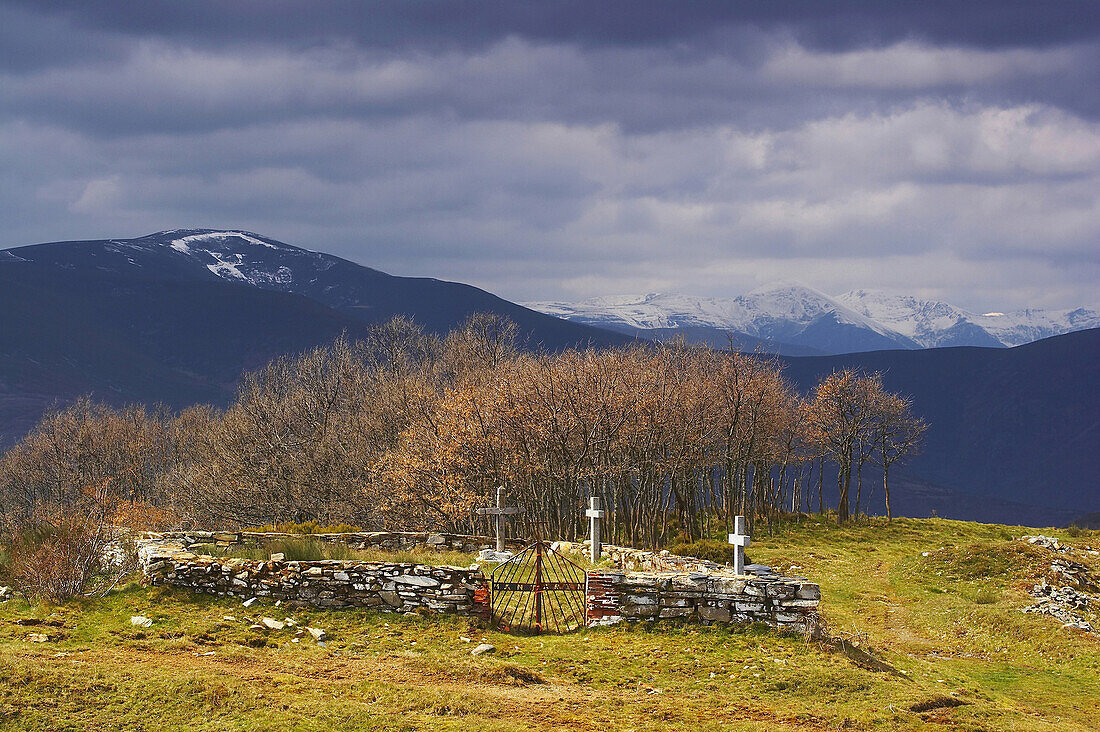 Cemetery in the village of Manjarin, with snow on the distant mountain range, Montes de Leon, Puerto de Rabanal, Castilla Leon, Spain