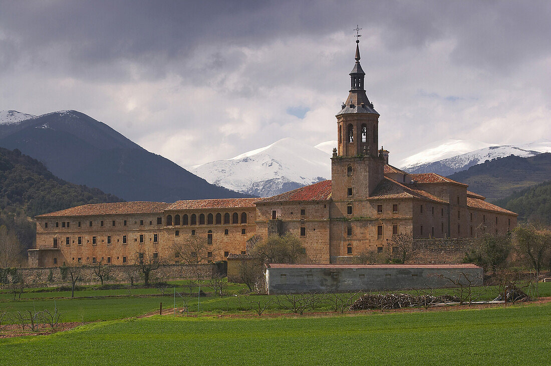 Snow topped mountain range, Sierra de la Demanda, behind a monastery, Monasterio de Yuso, San Millan de la Cogolla, La Rioja, Spain