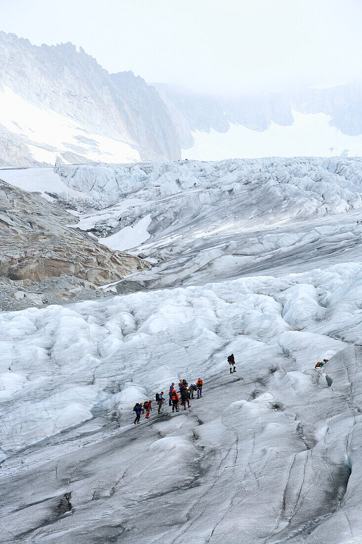 Group of people hiking on Rhône Glacier, Valais, Switzerland