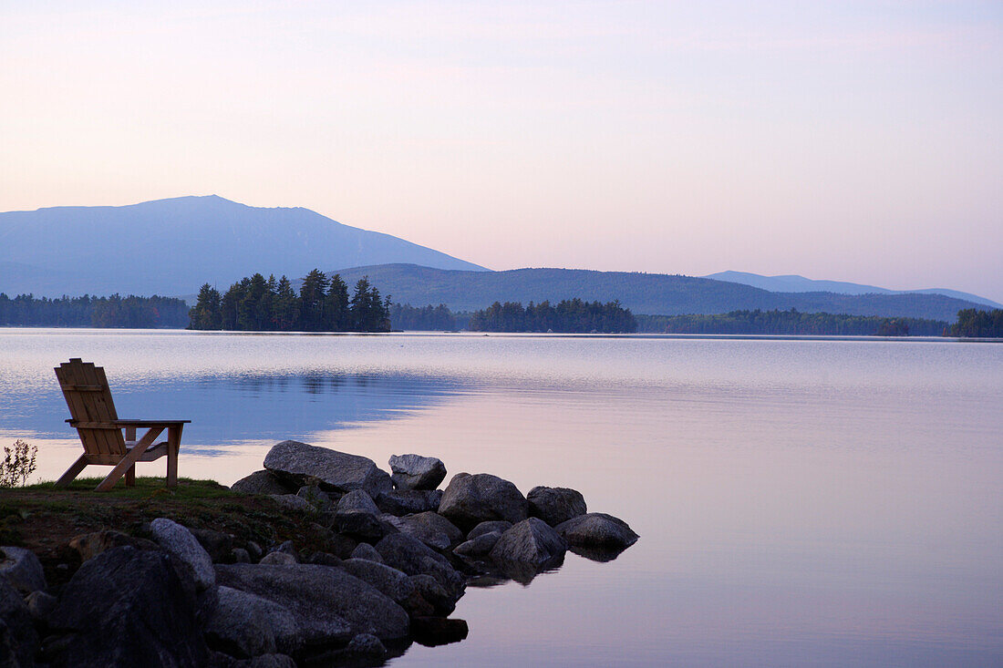 An empty Adirondeck chair on Lake Millinocket, Maine, ,USA