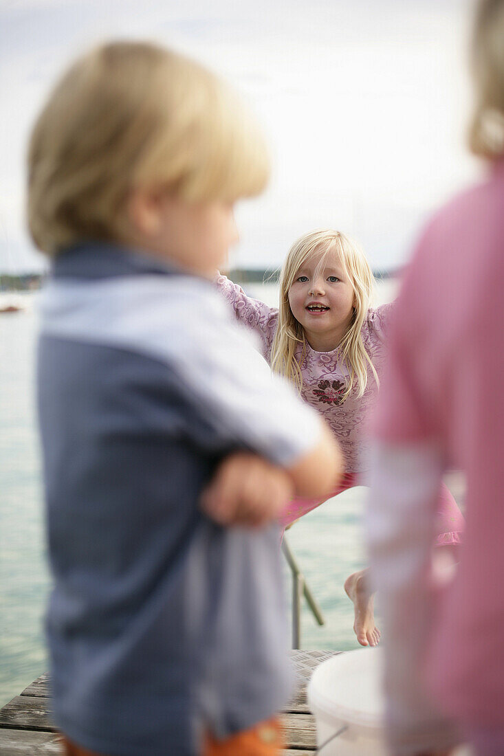 Children on jetty at Lake Woerthsee, Bavaria, Germany, MR