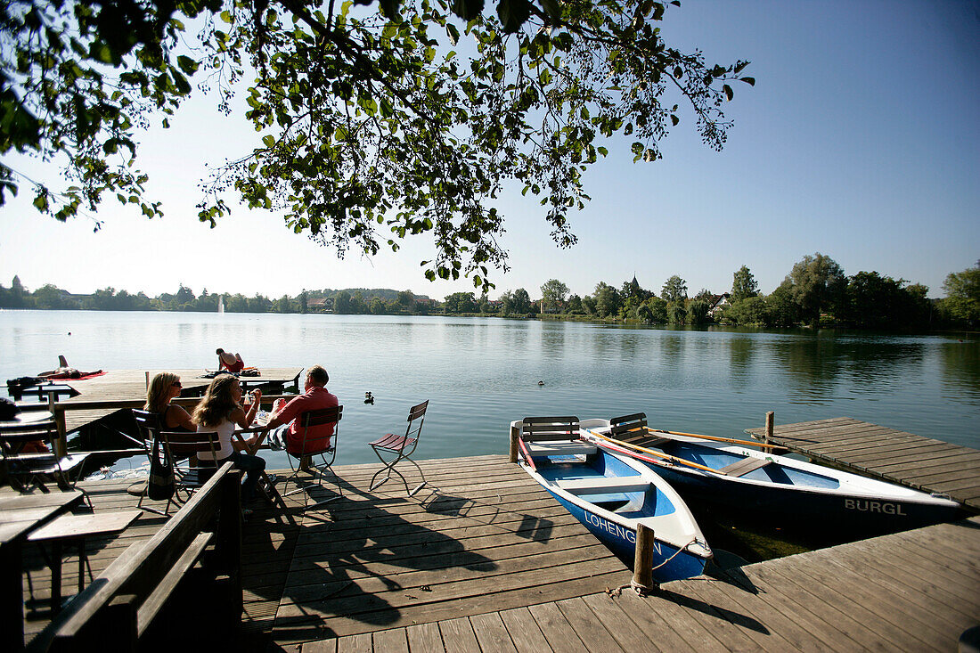 People sitting on the terrace of a cafe, rental boats, Wesslinger See, Upper Bavaria, Bavaria, Germany