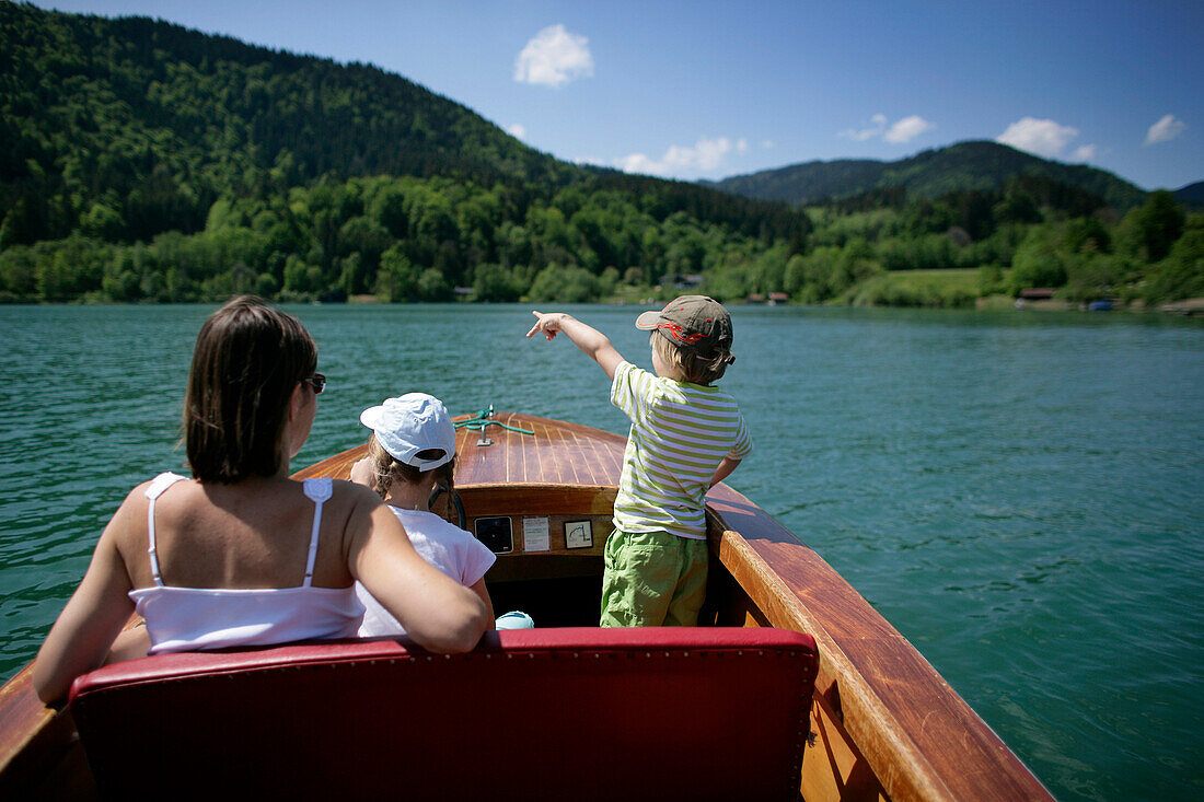 Mother and children in electric rental boat, Lake Tegernsee, Upper Bavaria, Bavaria, Germany, MR
