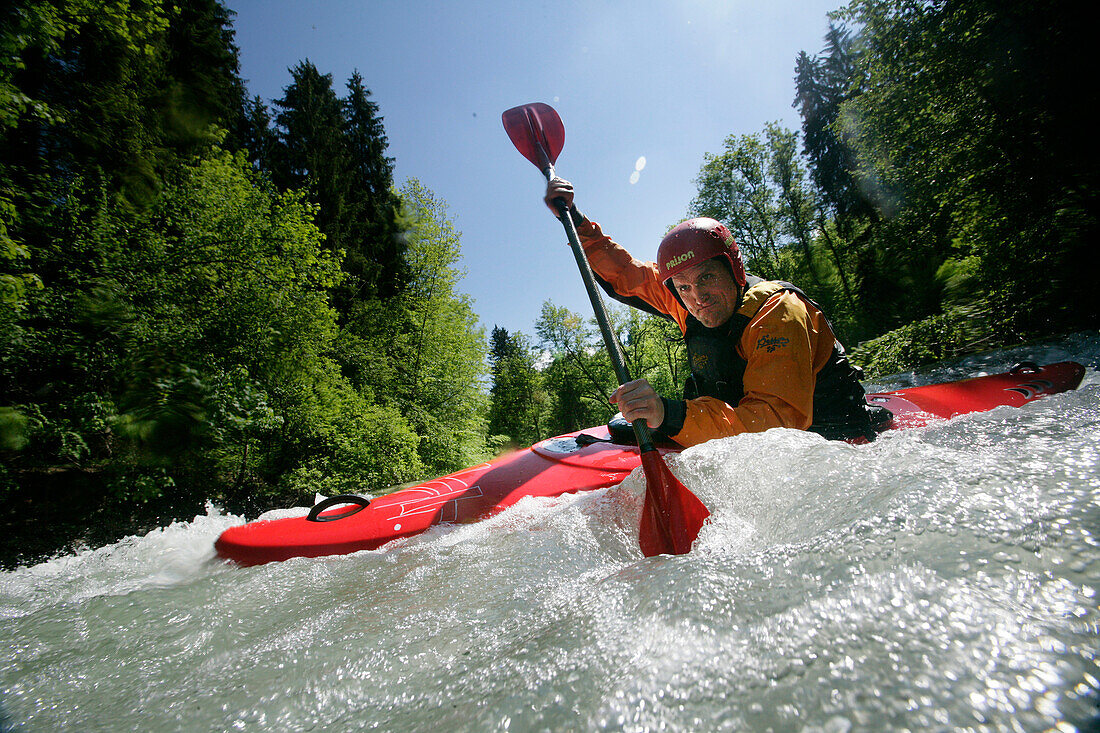 Man in a kayak, kayak weekend for beginners on the Mangfall river, Upper Bavaria, Germany