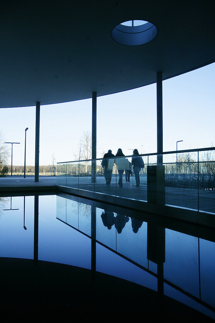 Persons passing Biozentrum of the Ludwig-Maximilians-University (LMU), Martinsried, Planegg, Bavaria, Germany