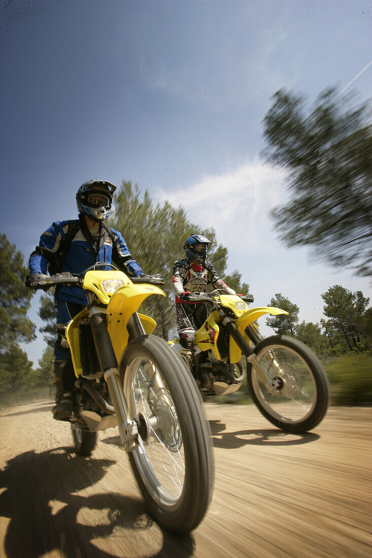 People driving offroad with motocross motorbikes, Suzuki Offroad Camp, Valencia, Spain