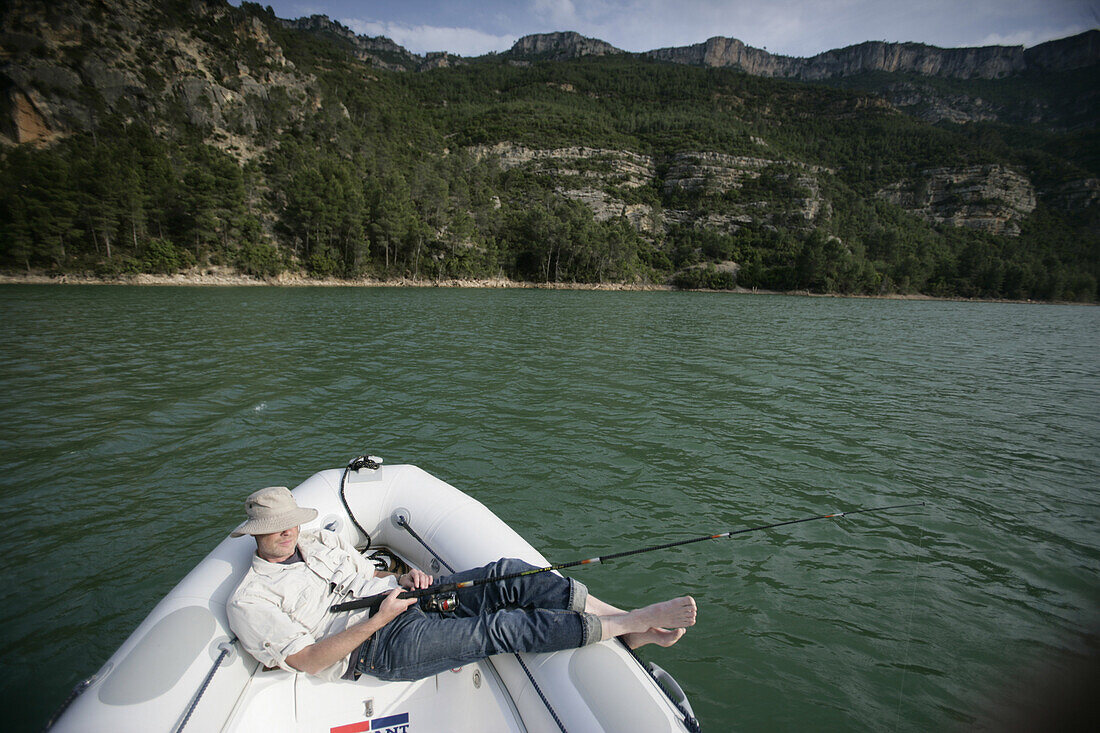 Man fishing from boat, reservoir, lake, Valencia region, Spain