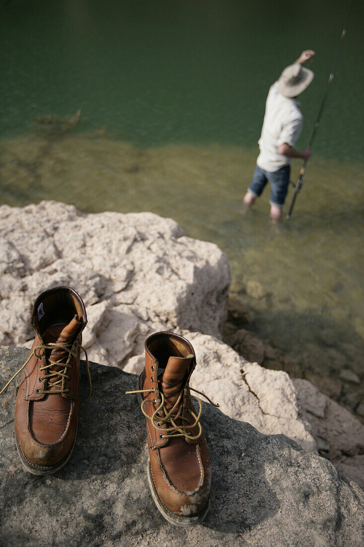 Man fishing at a reservoir, Bavaria, Germany