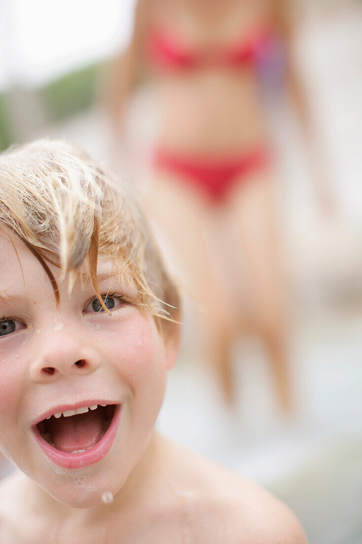 Wet boy (3-4 years) laughing at camera, Bavaria, Germany, MR
